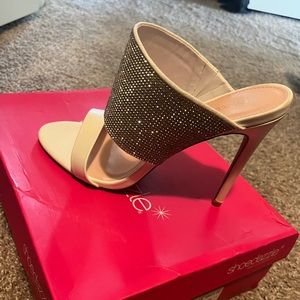 White sparkle mule slides.